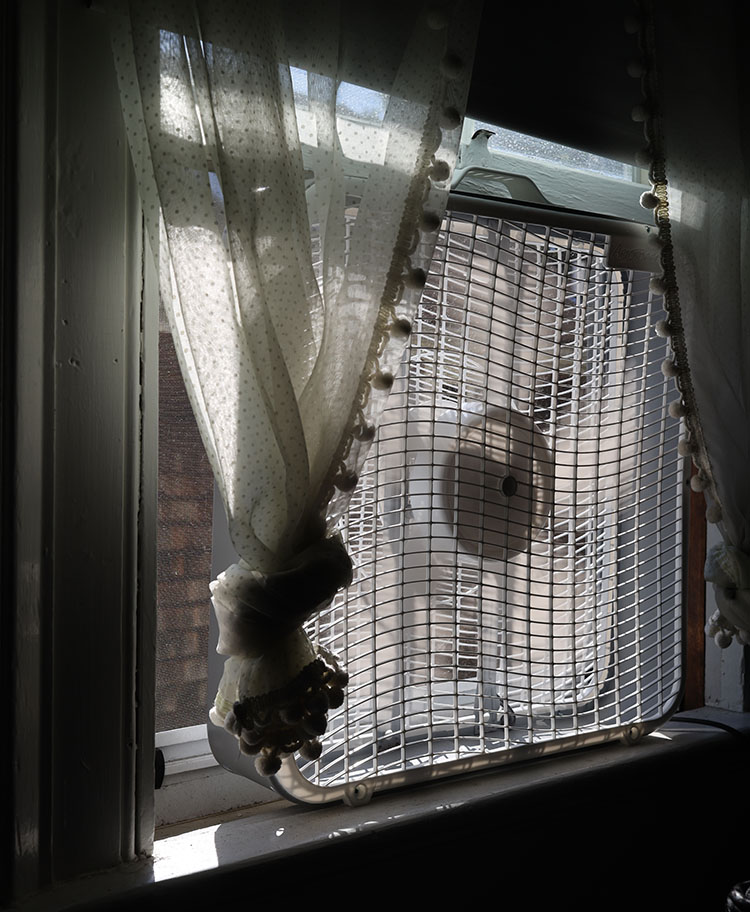 High Contrast Color Photo of Window, Curtins and Fan.